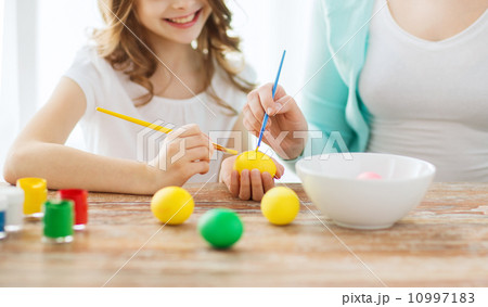 close up of little girl and mother coloring eggs close up of little girl and mother coloring eggs 10997183