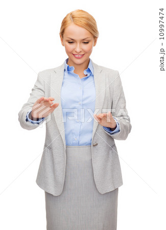 smiling businesswoman pointing to something smiling businesswoman pointing to something 10997474