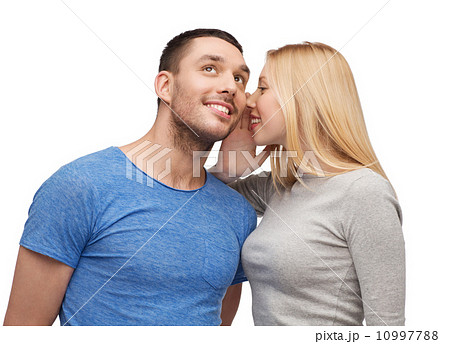 smiling girlfriend telling boyfriend secret 10997788