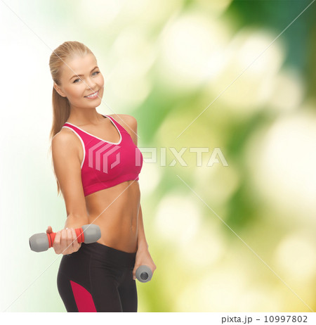 young sporty woman with light dumbbells 10997802