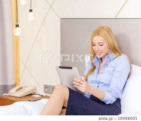 happy businesswoman with tablet pc in hotel room happy businesswoman with tablet pc in hotel room 10998005