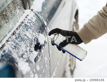 closeup of man hand with lock door de-icer closeup of man hand with lock door de-icer 10998166