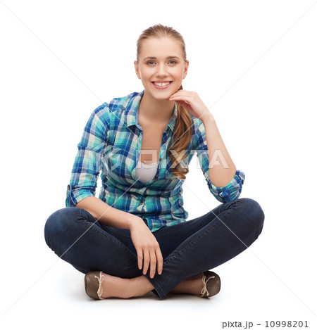 young woman in casual clothes sitting on floor 10998201