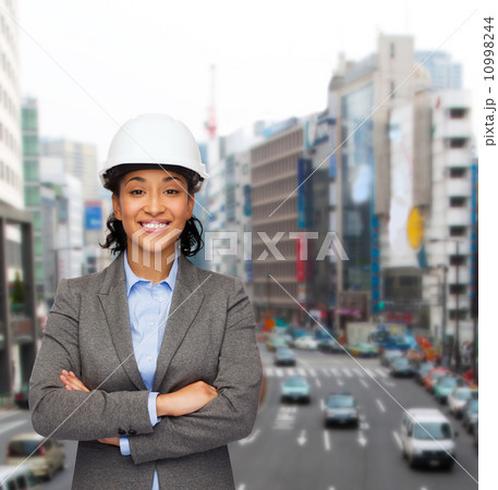 businesswoman in white helmet with crossed arms businesswoman in white helmet with crossed arms 10998244
