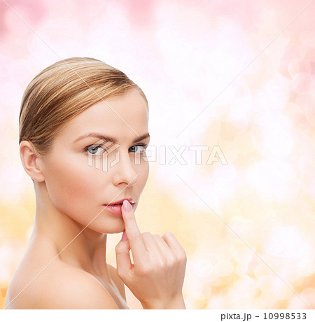 young woman doing hush gesrute 10998533