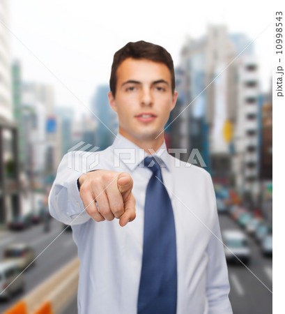 friendly young buisnessman pointing finger friendly young buisnessman pointing finger 10998543