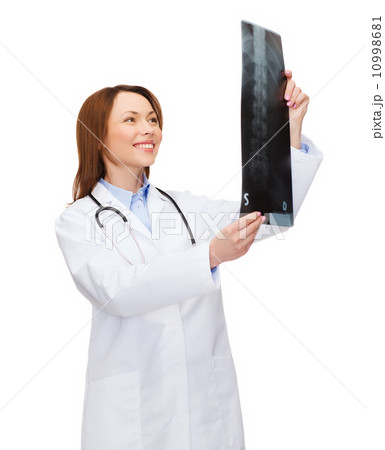 smiling female doctor looking at x-ray smiling female doctor looking at x-ray 10998681