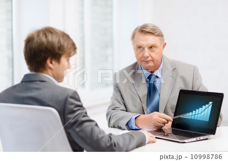 older man and young man with laptop computer older man and young man with laptop computer 10998786