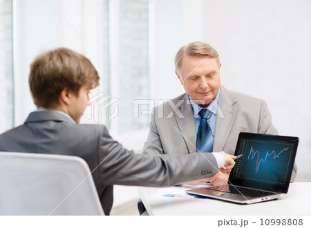 older man and young man with laptop computer 10998808