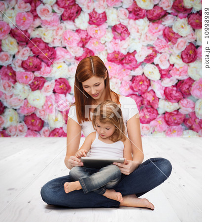 happy mother with little girl and tablet pc happy mother with little girl and tablet pc 10998989