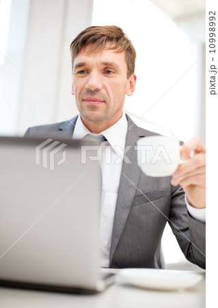 smiling businessman working with laptop computer smiling businessman working with laptop computer 10998992