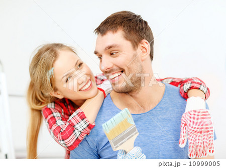 smiling couple covered with paint with paint brush smiling couple covered with paint with paint brush 10999005