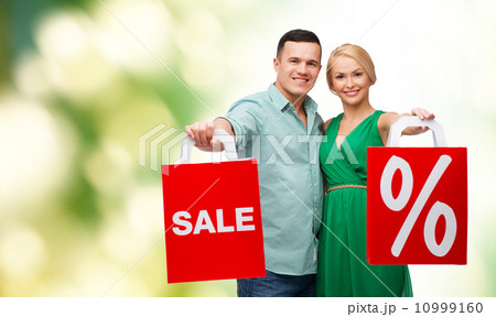smiling couple with shopping bags smiling couple with shopping bags 10999160
