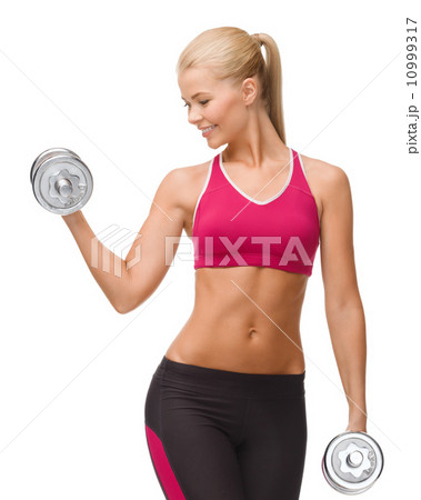 smiling woman lifting steel dumbbell smiling woman lifting steel dumbbell 10999317