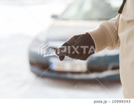 closeup of man hand with car key outdoors 10999343