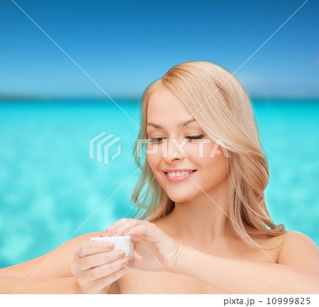 beautiful woman applying cream 10999825