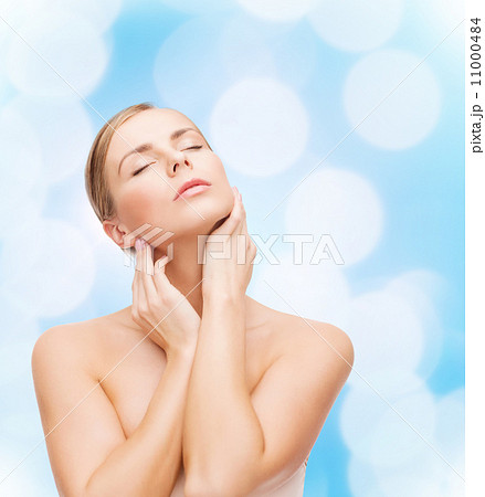 beautiful woman touching her face with closed eyes 11000484