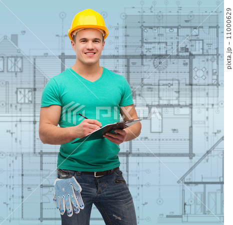 smiling man in helmet with clipboard 11000629