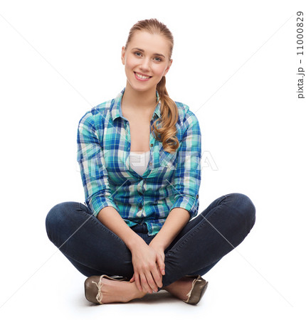 young woman in casual clothes sitting on floor 11000829