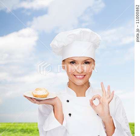 smiling female chef with cake on plate smiling female chef with cake on plate 11000862