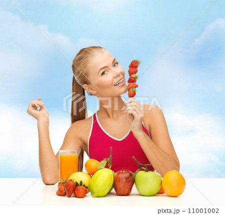 smiling woman with organic food eating strawberry smiling woman with organic food eating strawberry 11001002