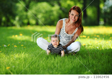 Mother and daughter on the green grass Mother and daughter on the green grass 11002456