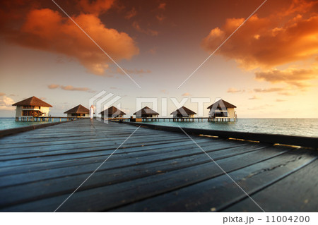 woman in a dress on maldivian sunset woman in a dress on maldivian sunset 11004200