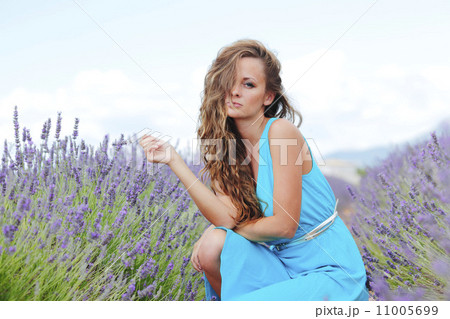 Woman sitting on a lavender field Woman sitting on a lavender field 11005699