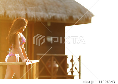 Woman near tropical hotel Woman near tropical hotel 11006343