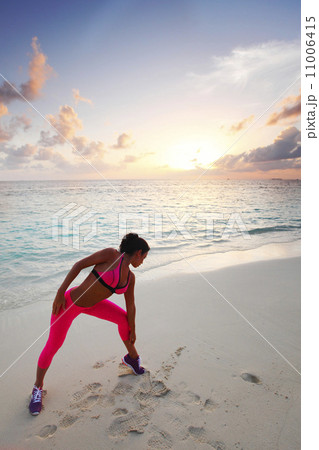 Woman stretching on beach 11006415