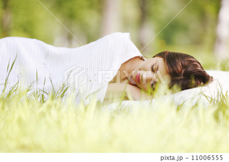 Woman sleeping on grass 11006555