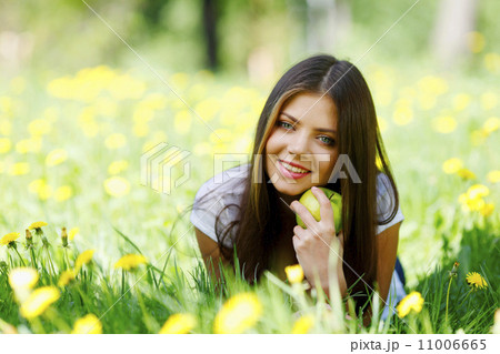 Woman with apple outdoors 11006665
