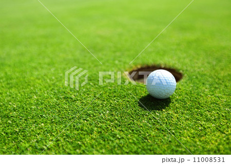 golf ball on lip of cup golf ball on lip of cup 11008531