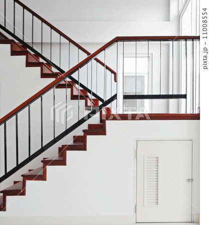Storage room under wooden staircase 11008554