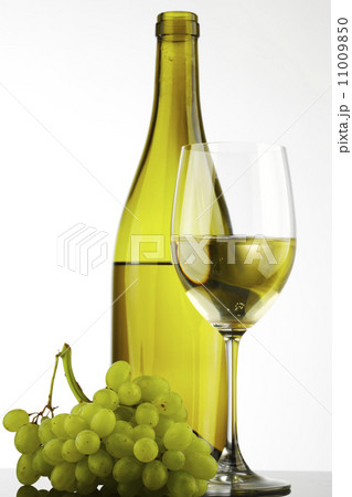 bottle with white wine and glass and grapes 11009850