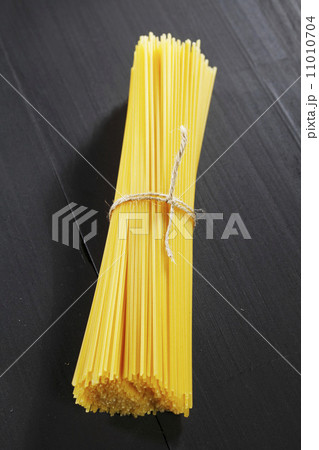 Raw pasta on black table Raw pasta on black table 11010704