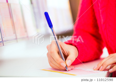 Young woman in Lotto shop playing ticket Young woman in Lotto shop playing ticket 11012590