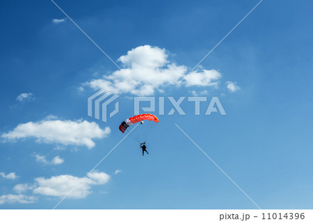 unidentified skydiver on blue sky 11014396