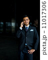 Confident businessman with phone 11017306