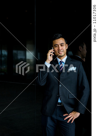 Confident businessman with phone 11017306