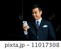 Confident businessman with phone 11017308