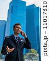 Confident businessman with phone 11017310