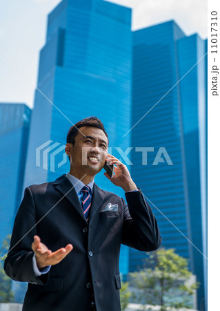 Confident businessman with phone Confident businessman with phone 11017310
