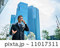 Confident businessman with phone 11017311