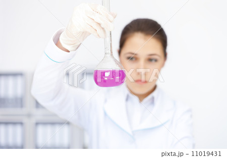 Young chemical female researcher working with chemicals 11019431