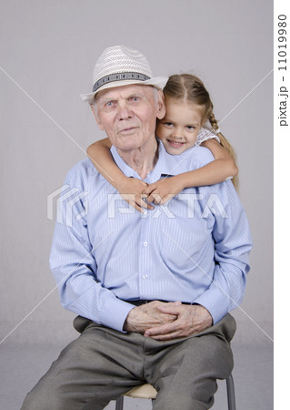 Portrait of an old man eighty years with granddaughter 11019980