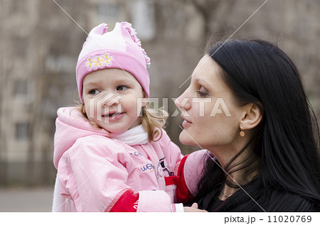little girl thoughtfully lies on shoulder of my mother little girl thoughtfully lies on shoulder of my mother 11020769