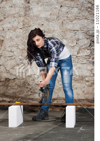 Young long-haired woman with an angle grinder Young long-haired woman with an angle grinder 11021166