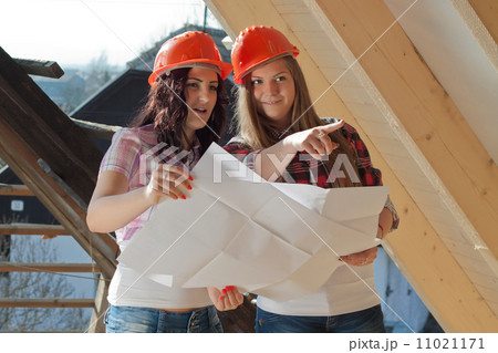 Two young women workers on the roof Two young women workers on the roof 11021171