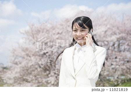 桜の前に立つ新入社員の女性 桜の前に立つ新入社員の女性 11021819
